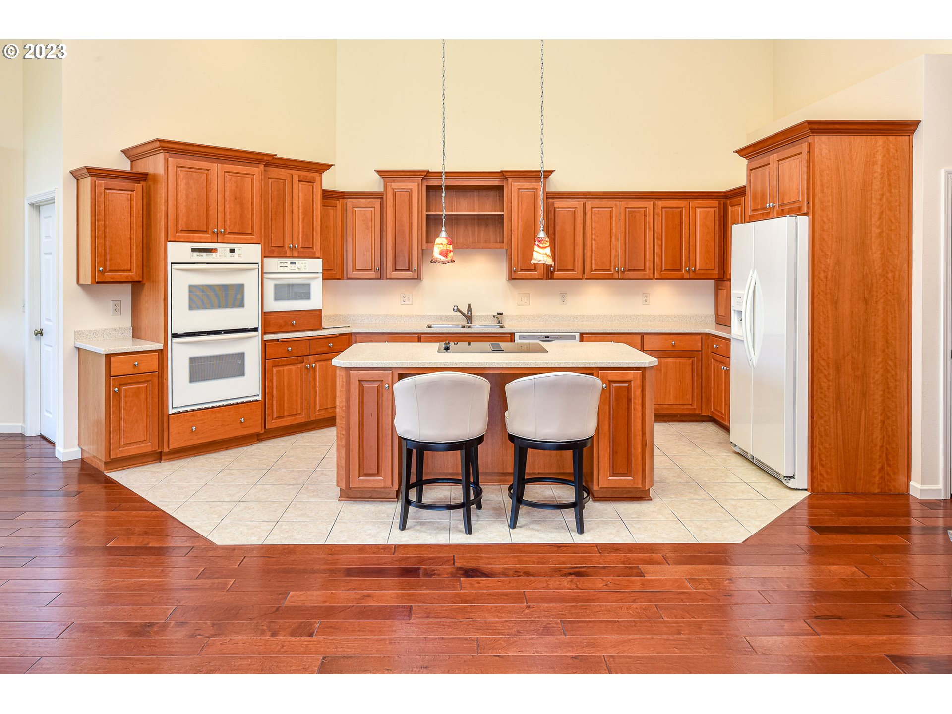2002 Lake Shore Drive Eugene, OR 97408 - Photo 16 of 37 a kitchen with stainless steel appliances granite countertop a stove top oven a refrigerator and cabinets