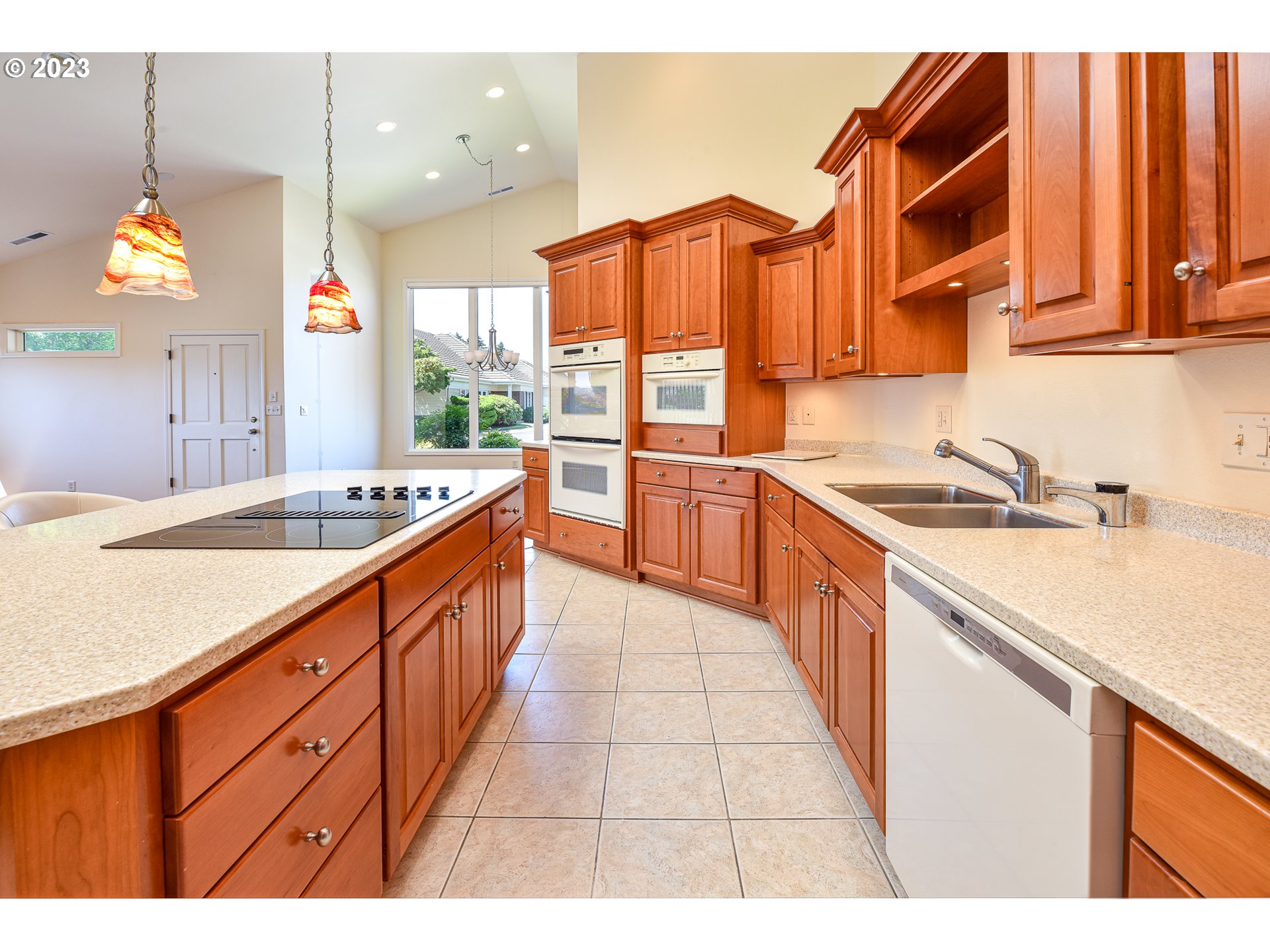 2002 Lake Shore Drive Eugene, OR 97408 - Photo 19 of 37 a large kitchen with kitchen island granite countertop a sink and a wooden floor