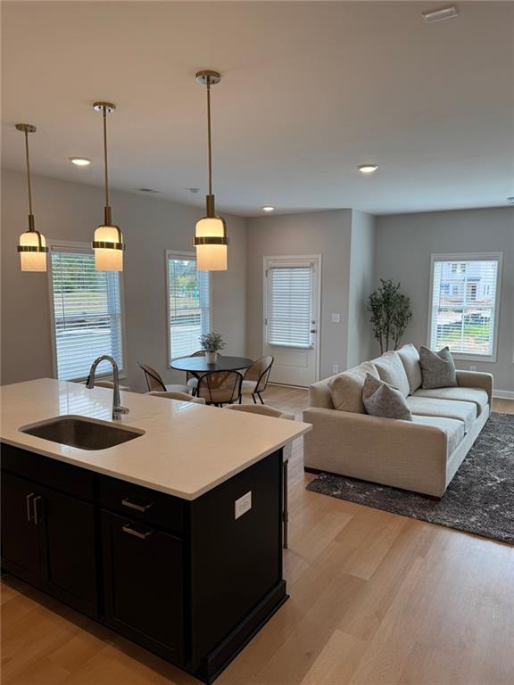 1925 Appian Alley Kennesaw, GA 30144 - Photo 9 of 27 a living room with furniture a chandelier and a view of kitchen