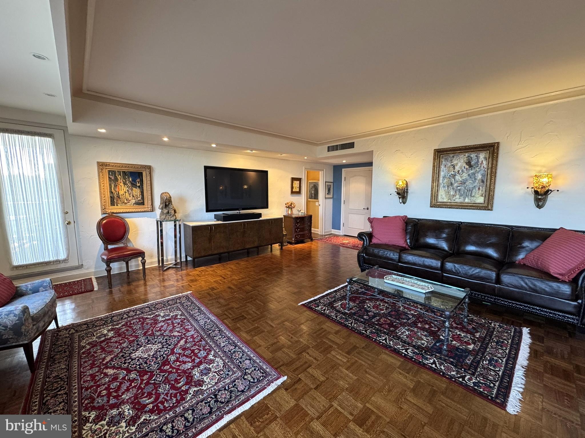 191 Presidential Boulevard, Unit R816 Bala Cynwyd, PA 19004 - Photo 21 of 42 a living room with furniture and a flat screen tv