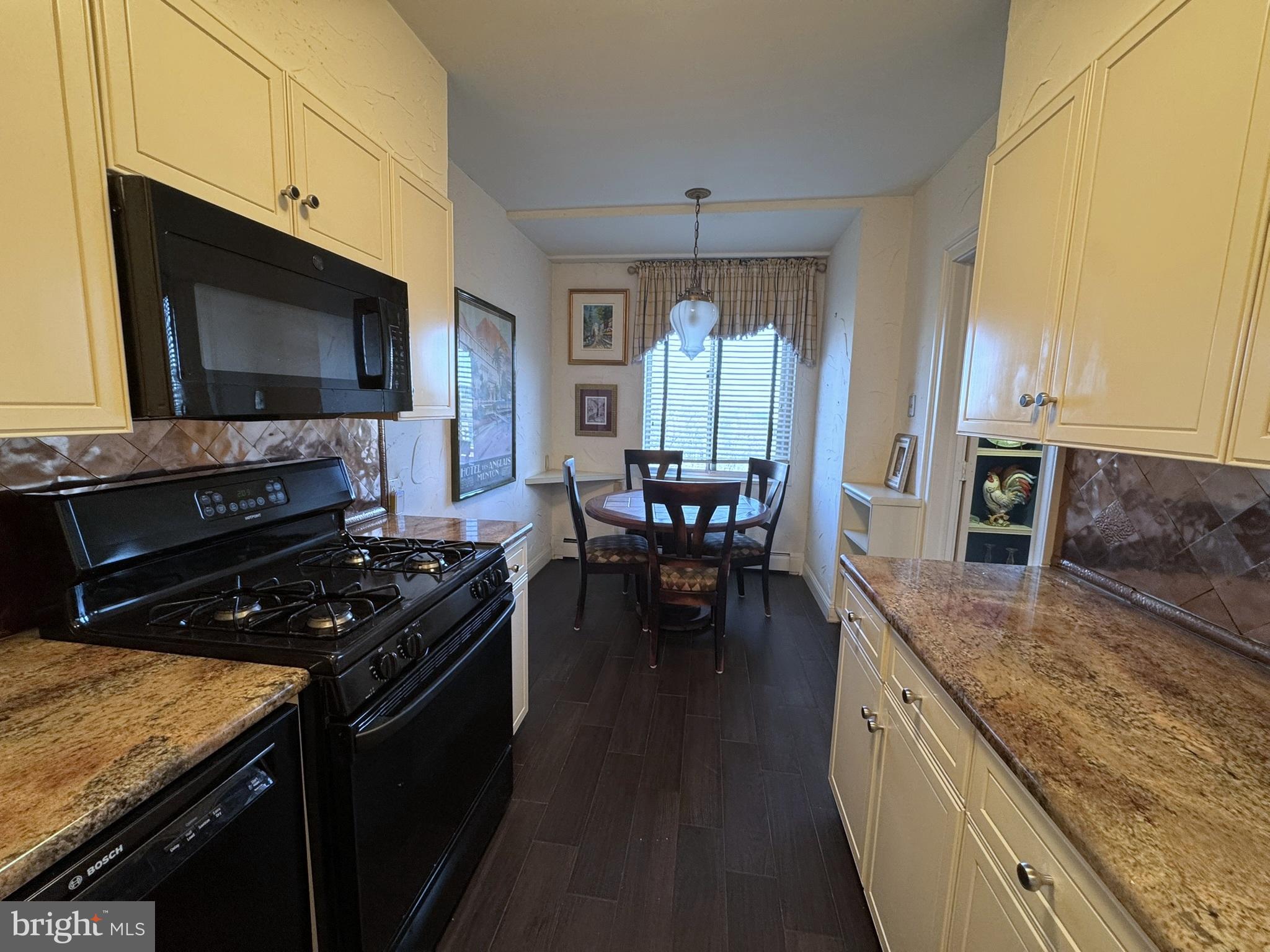 191 Presidential Boulevard, Unit R816 Bala Cynwyd, PA 19004 - Photo 26 of 42 a kitchen with stainless steel appliances granite countertop a stove a sink and a microwave