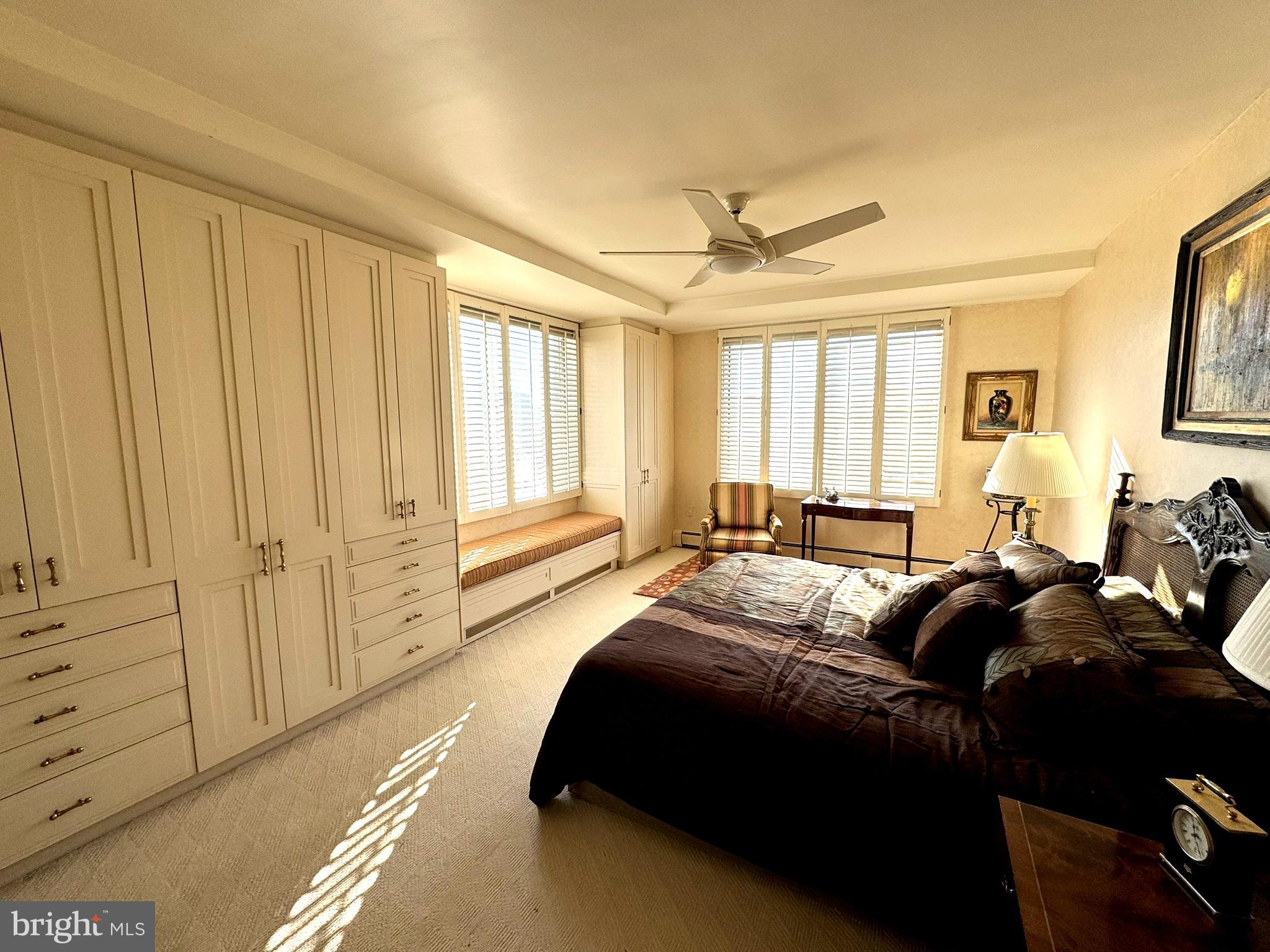 191 Presidential Boulevard, Unit R816 Bala Cynwyd, PA 19004 - Photo 32 of 42 a spacious bedroom with a bed a dresser and a window