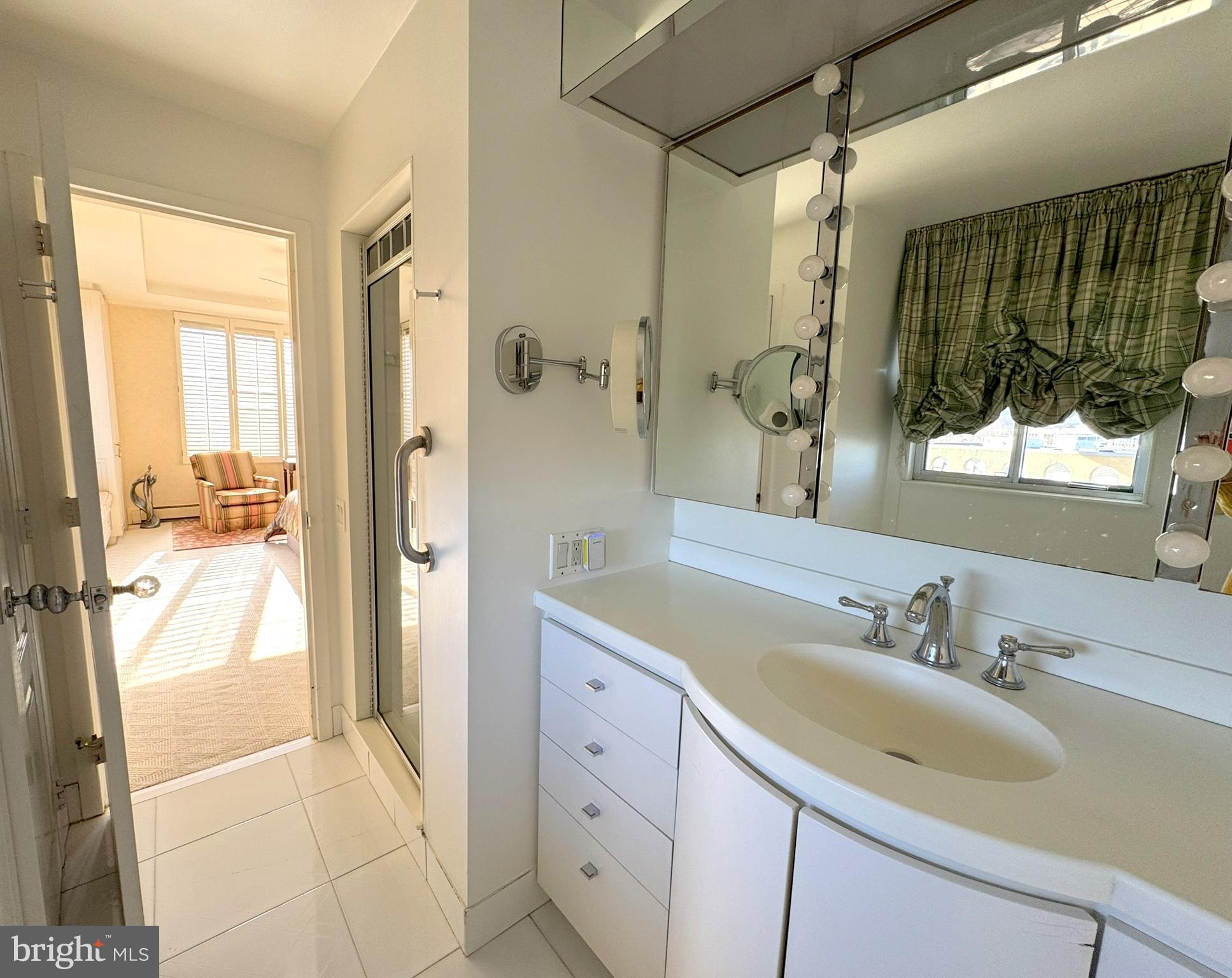 191 Presidential Boulevard, Unit R816 Bala Cynwyd, PA 19004 - Photo 35 of 42 a bathroom with a sink and a mirror