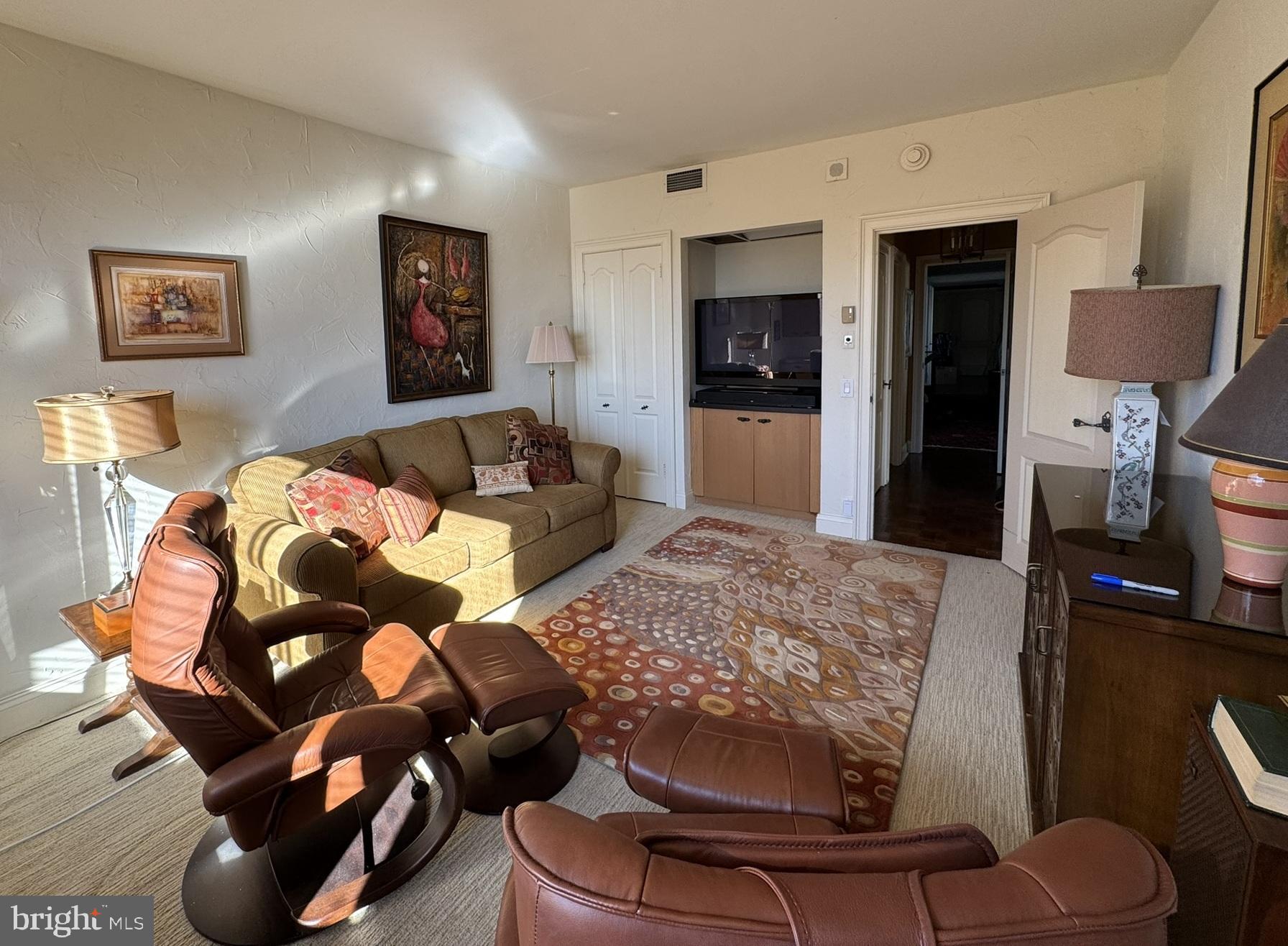191 Presidential Boulevard, Unit R816 Bala Cynwyd, PA 19004 - Photo 39 of 42 a living room with furniture and a flat screen tv