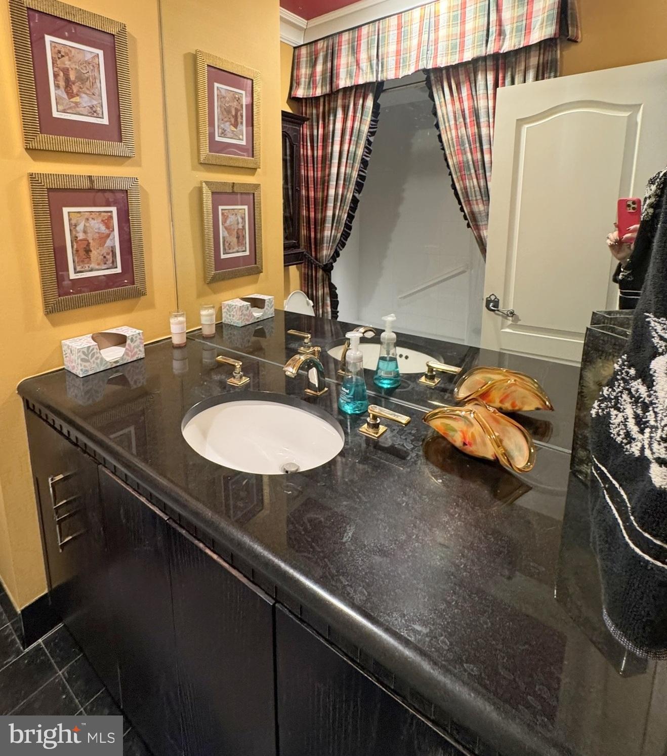 191 Presidential Boulevard, Unit R816 Bala Cynwyd, PA 19004 - Photo 41 of 42 a bathroom with a sink and a mirror