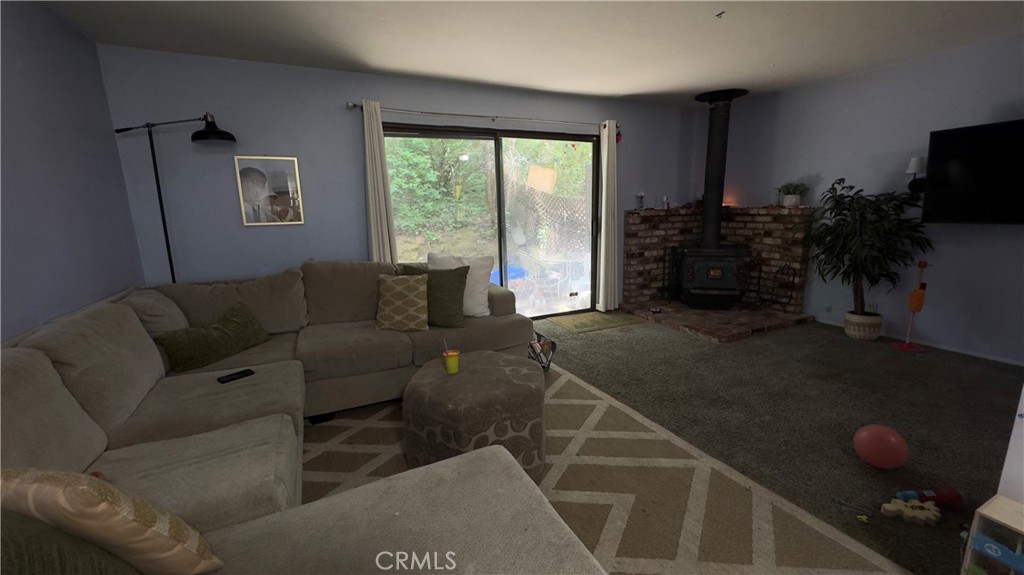 25248 Robinson Road Willits, CA 95490 - Photo 2 of 19 a living room with furniture a flat screen tv and a large window