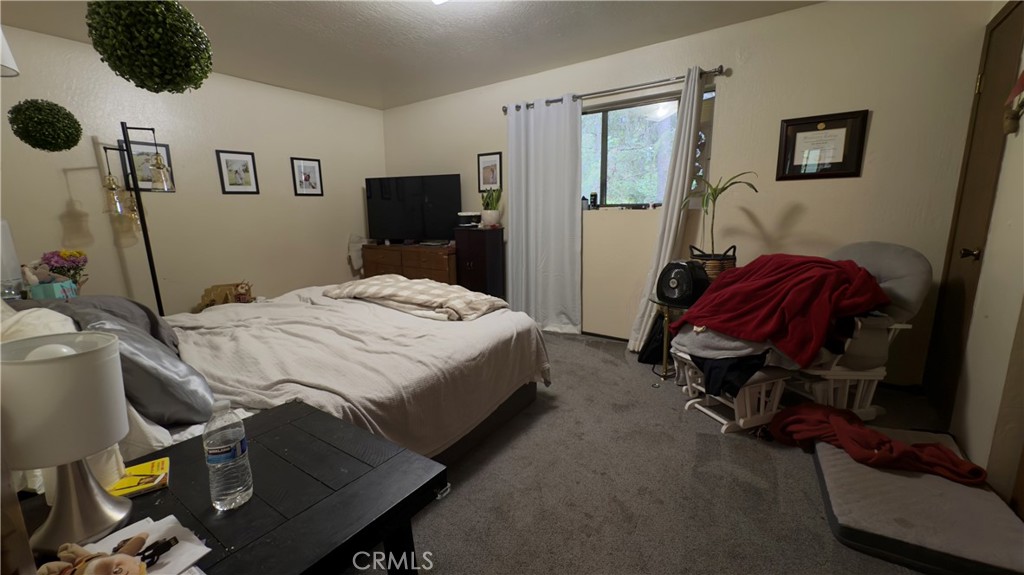 25248 Robinson Road Willits, CA 95490 - Photo 6 of 19 a bedroom with a bed and cabinets