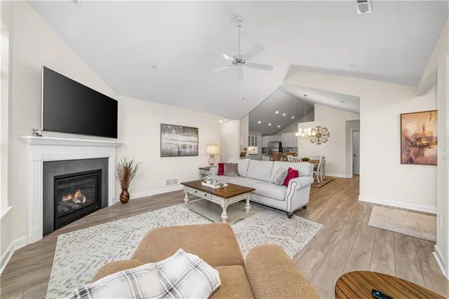 a living room with furniture fireplace and flat screen tv