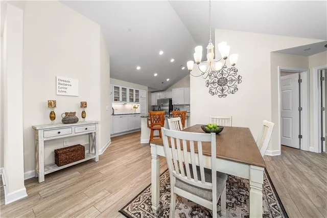a view of a livingroom with furniture wooden floor and windows