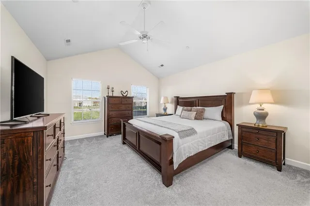 a spacious bedroom with a bed and a flat screen tv