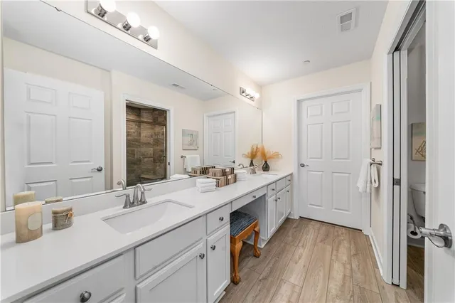 a view of a bathroom with a sink mirror and shower