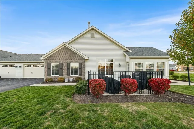 a front view of house with yard and green space