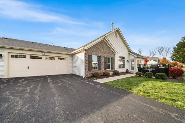 a view of a house with cars parked in front of a house