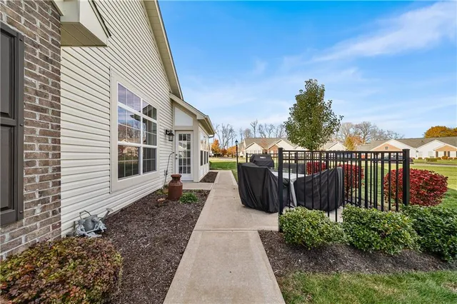 a view of a house with backyard and sitting area