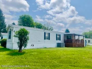 a view of house with backyard and a garden