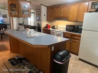 a kitchen with a sink a stove and cabinets