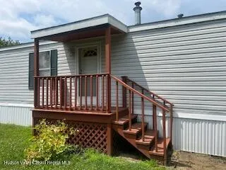 a view of a house with wooden fence