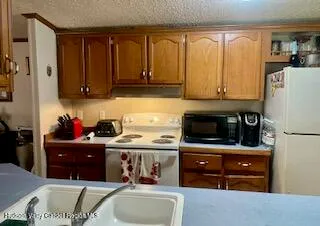 a kitchen with stainless steel appliances granite countertop a refrigerator and a stove