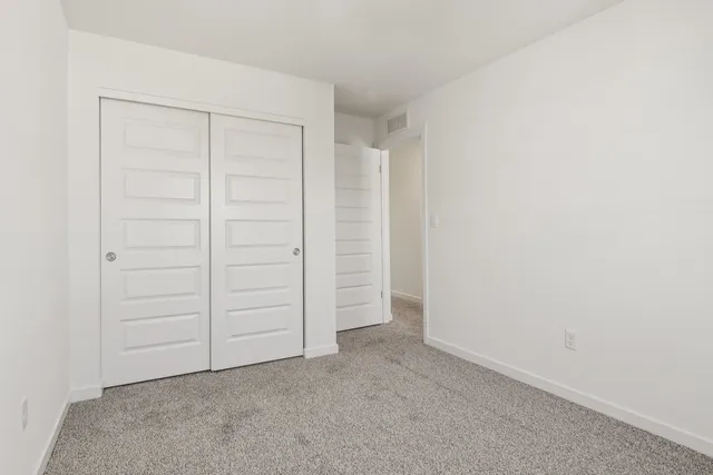 a living room with furniture and a potted plant on table