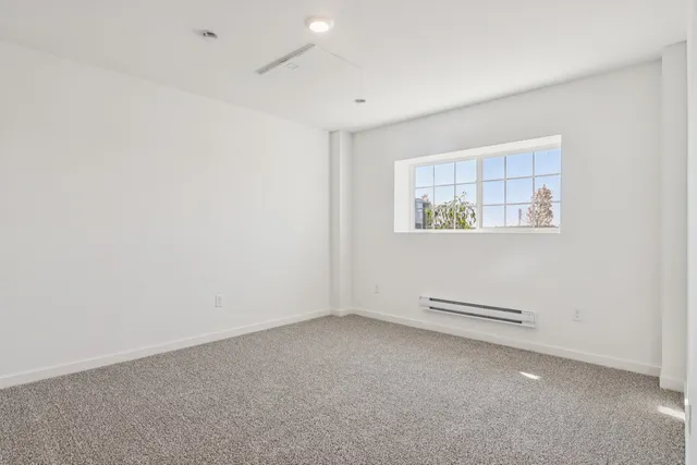 a bedroom with a bed and a night stand