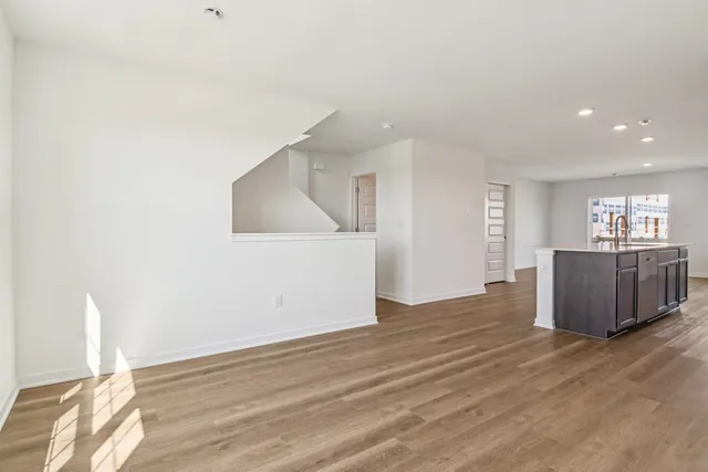 a view of a kitchen with wooden floor and window