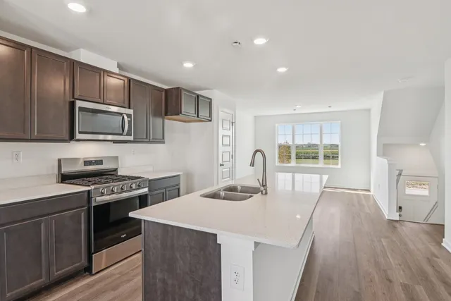 a kitchen with a sink a stove and refrigerator