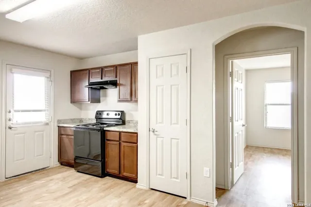 a kitchen with stainless steel appliances granite countertop a stove a sink and a refrigerator
