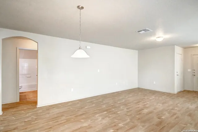 a view of a room with wooden floor and bathroom