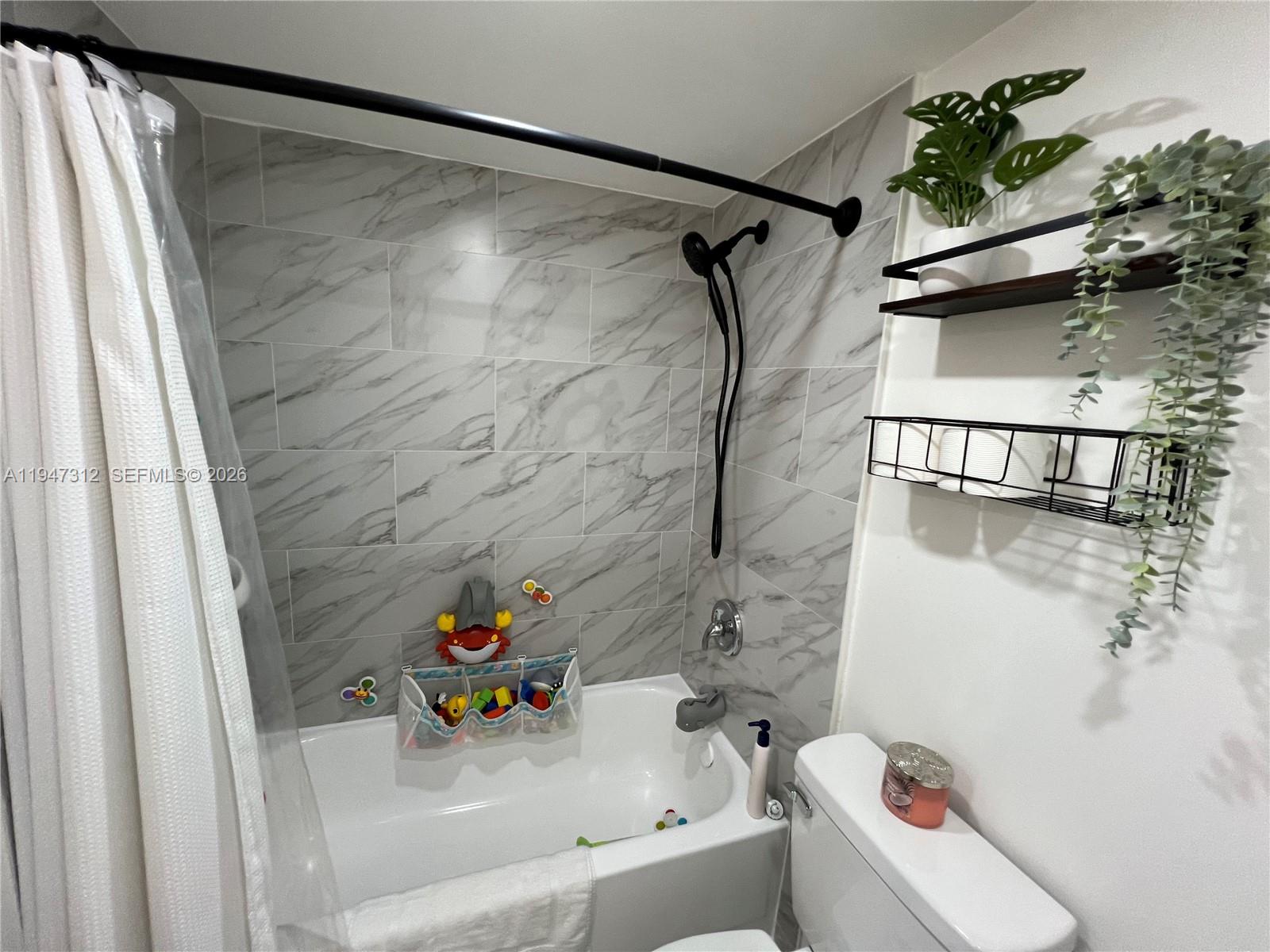 8425 Northwest 8th Street, Unit 406 Miami, FL 33126 - Photo 18 of 22 a bathroom with a sink and a shower