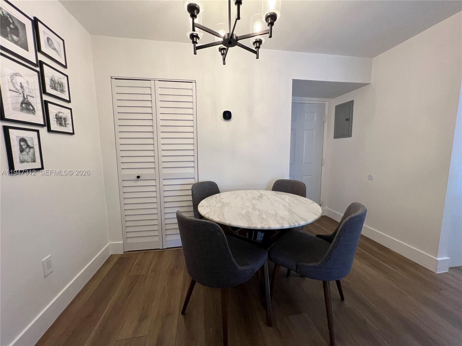 8425 Northwest 8th Street, Unit 406 Miami, FL 33126 - Photo 5 of 22 a view of a dining room with furniture and wooden floor