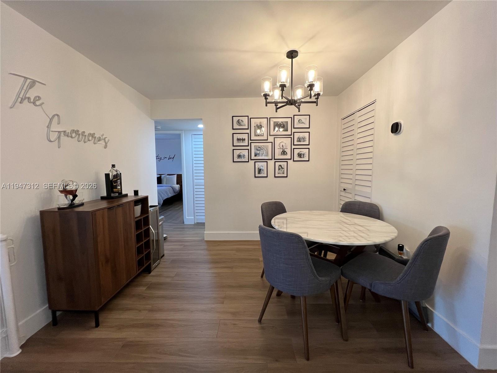8425 Northwest 8th Street, Unit 406 Miami, FL 33126 - Photo 6 of 22 a view of a dining room with furniture and wooden floor