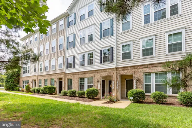front view of a brick house with a yard