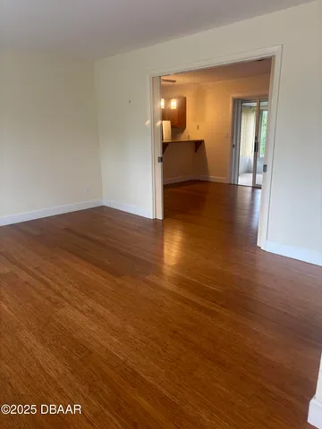 a view of a room with wooden floor and staircase