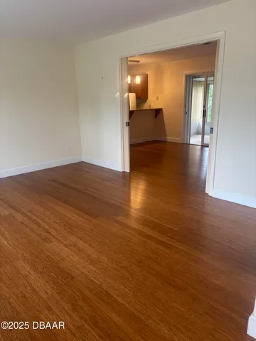 a view of a room with wooden floor