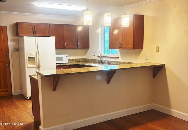 a kitchen with stainless steel appliances a refrigerator a sink and a stove