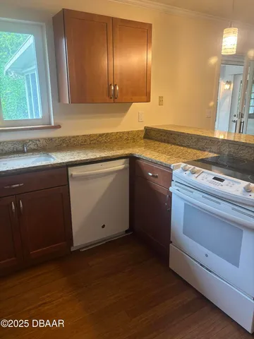 a kitchen with granite countertop cabinets stainless steel appliances and a sink