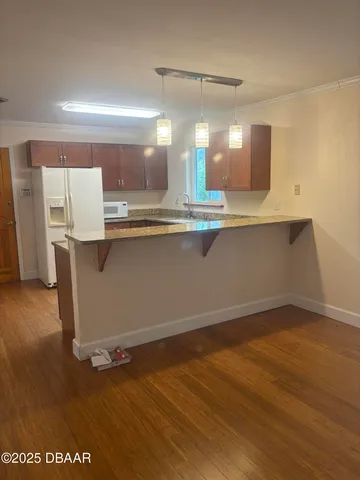 a view of a room with wooden floor