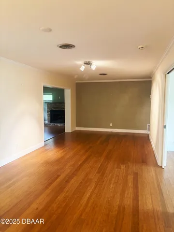a view of an empty room and wooden floor