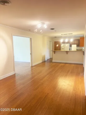 a view of a room with wooden floor