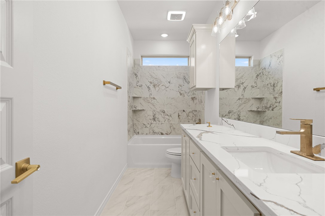 6512 Agave Court Bryan, TX 77808 - Photo 37 of 42 Full bathroom featuring double vanity, tub / shower combination, and light marble finish flooring