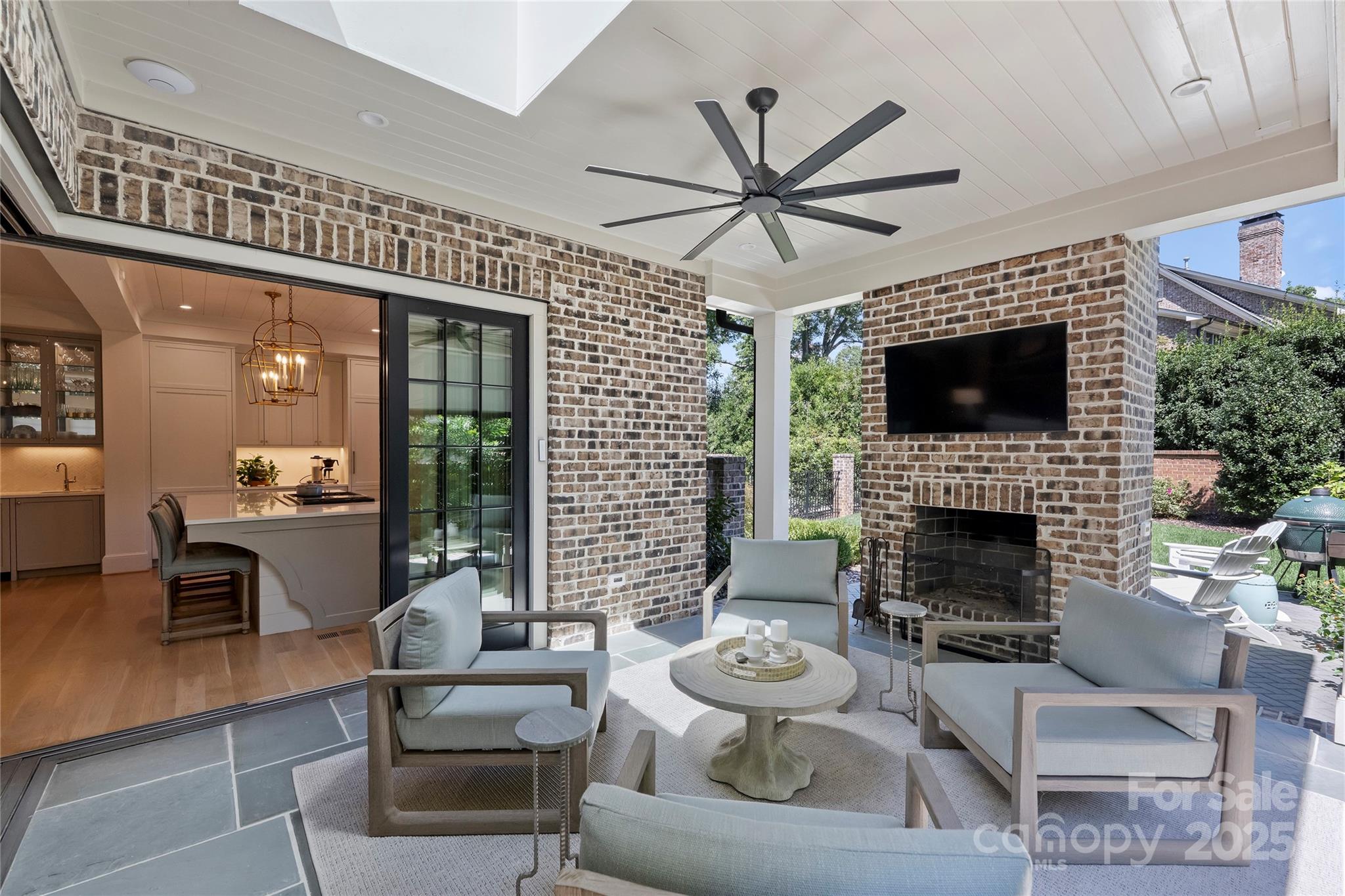 2355 Croydon Road Charlotte, NC 28207 - Photo 3 of 4 a living room with furniture a fireplace and a flat screen tv