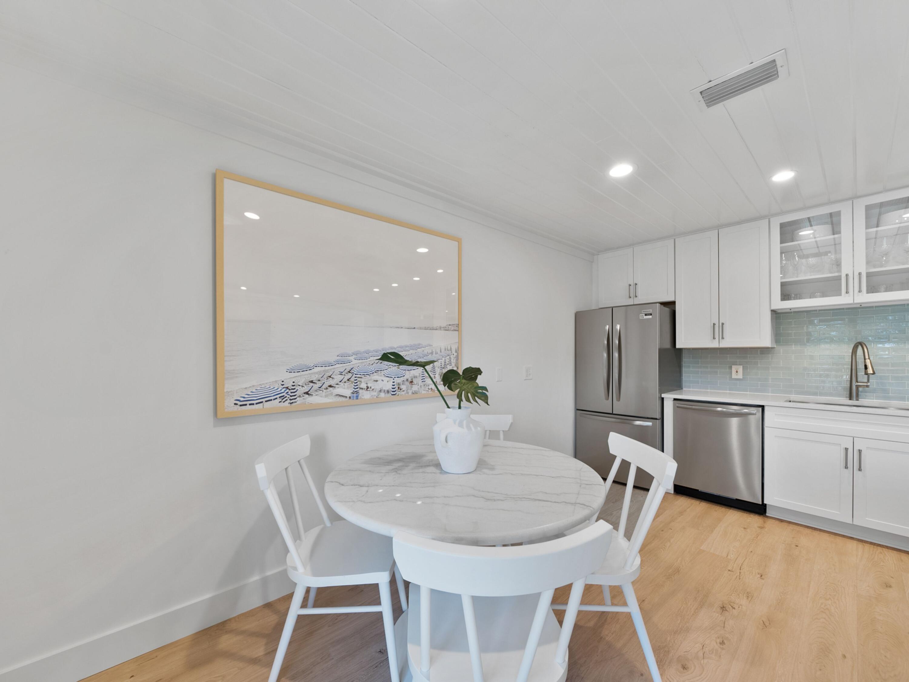 81 South Orange Street, Unit 205 Inlet Beach, FL 32461 - Photo 13 of 28 a kitchen with stainless steel appliances a dining table chairs and white cabinets
