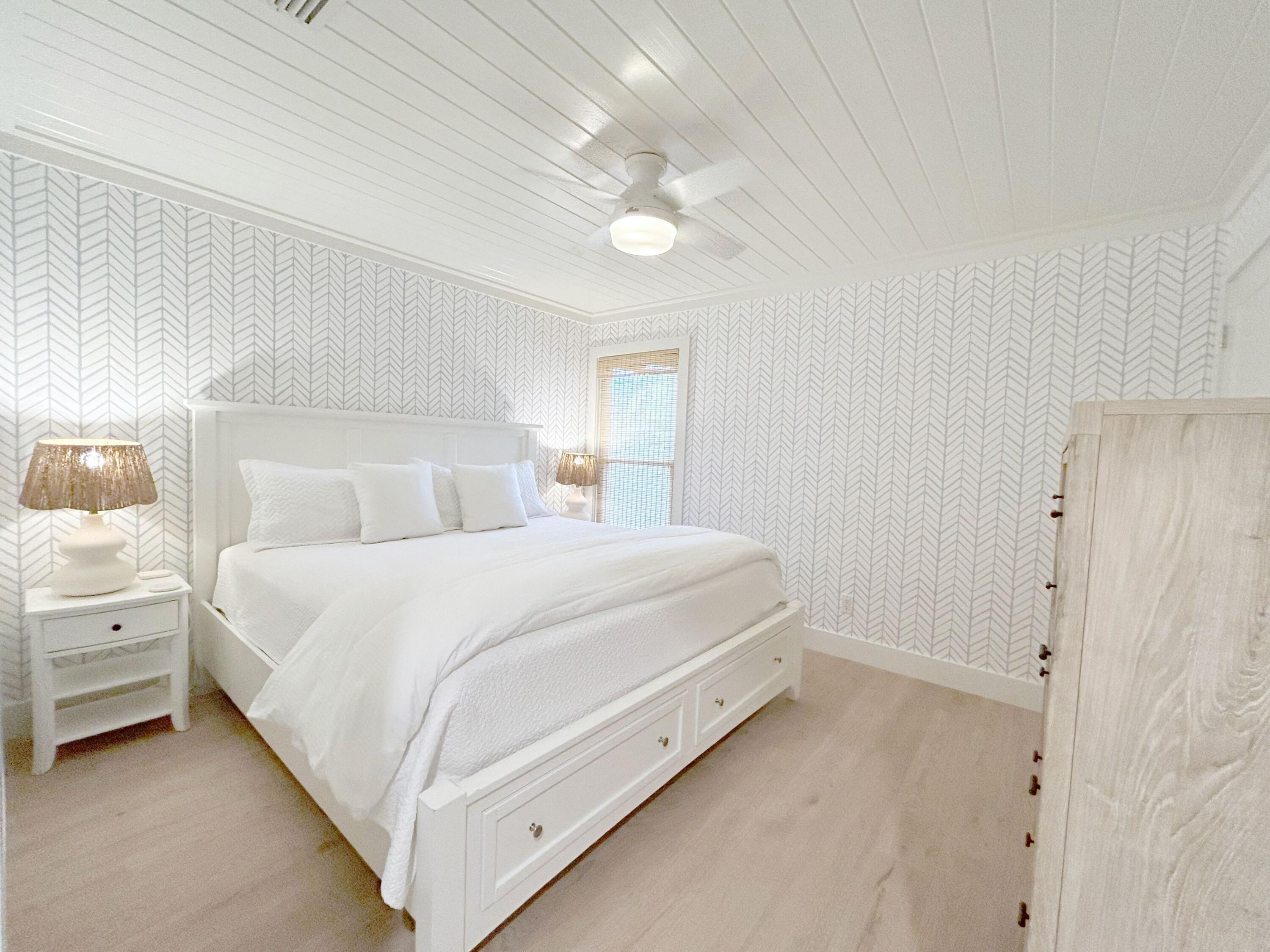 81 South Orange Street, Unit 205 Inlet Beach, FL 32461 - Photo 9 of 28 a bedroom with a bed and a night stand