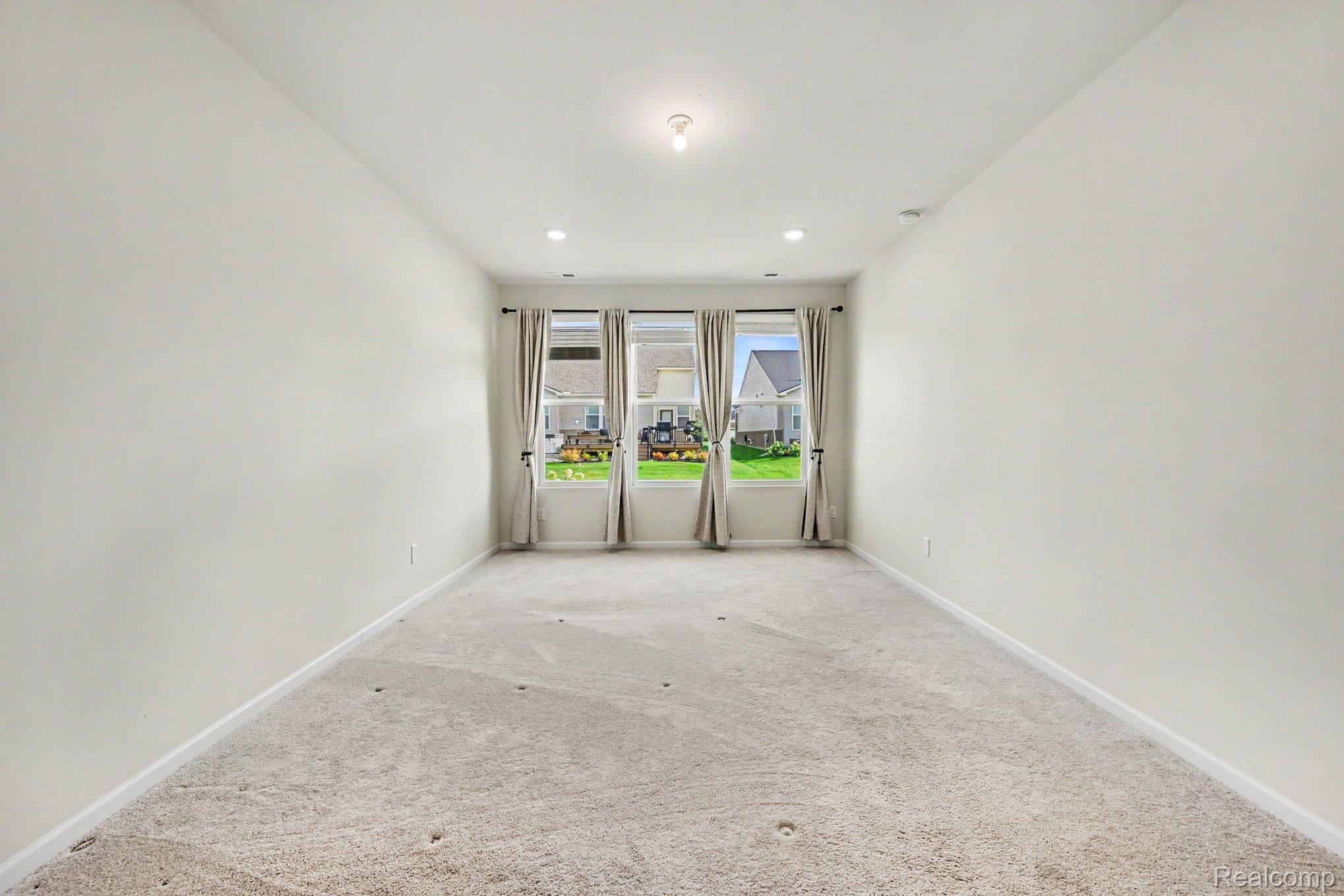 50153 Fowler Road Canton, MI 48188 - Photo 14 of 27 Light-toned wall finishes, recessed lighting, central ceiling fixture, and carpeted flooring