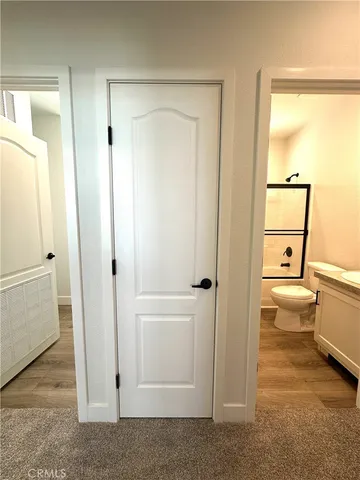a bathroom with a granite countertop sink a toilet and shower