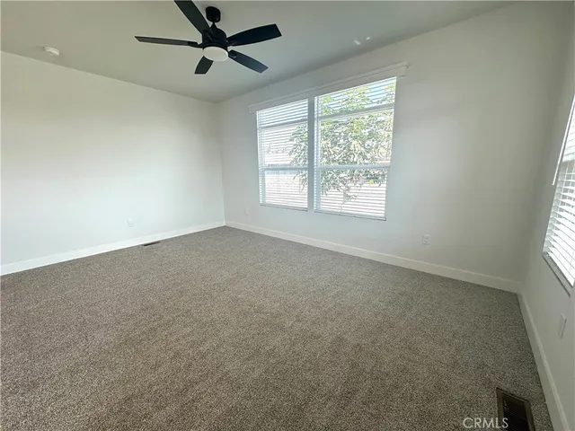 an empty room with closet and wooden door