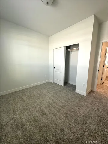 a view of a livingroom with a ceiling fan and window