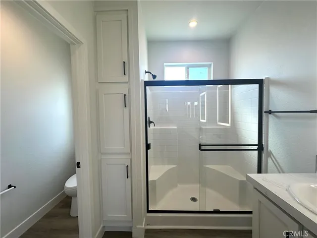a bathroom with a granite countertop sink mirror and shower