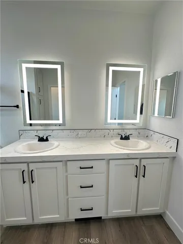 a bathroom with a double vanity sink and mirror