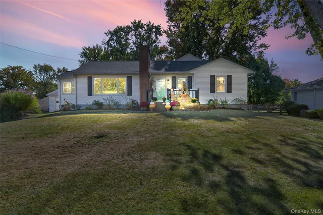 a view of a house with a yard and pathway